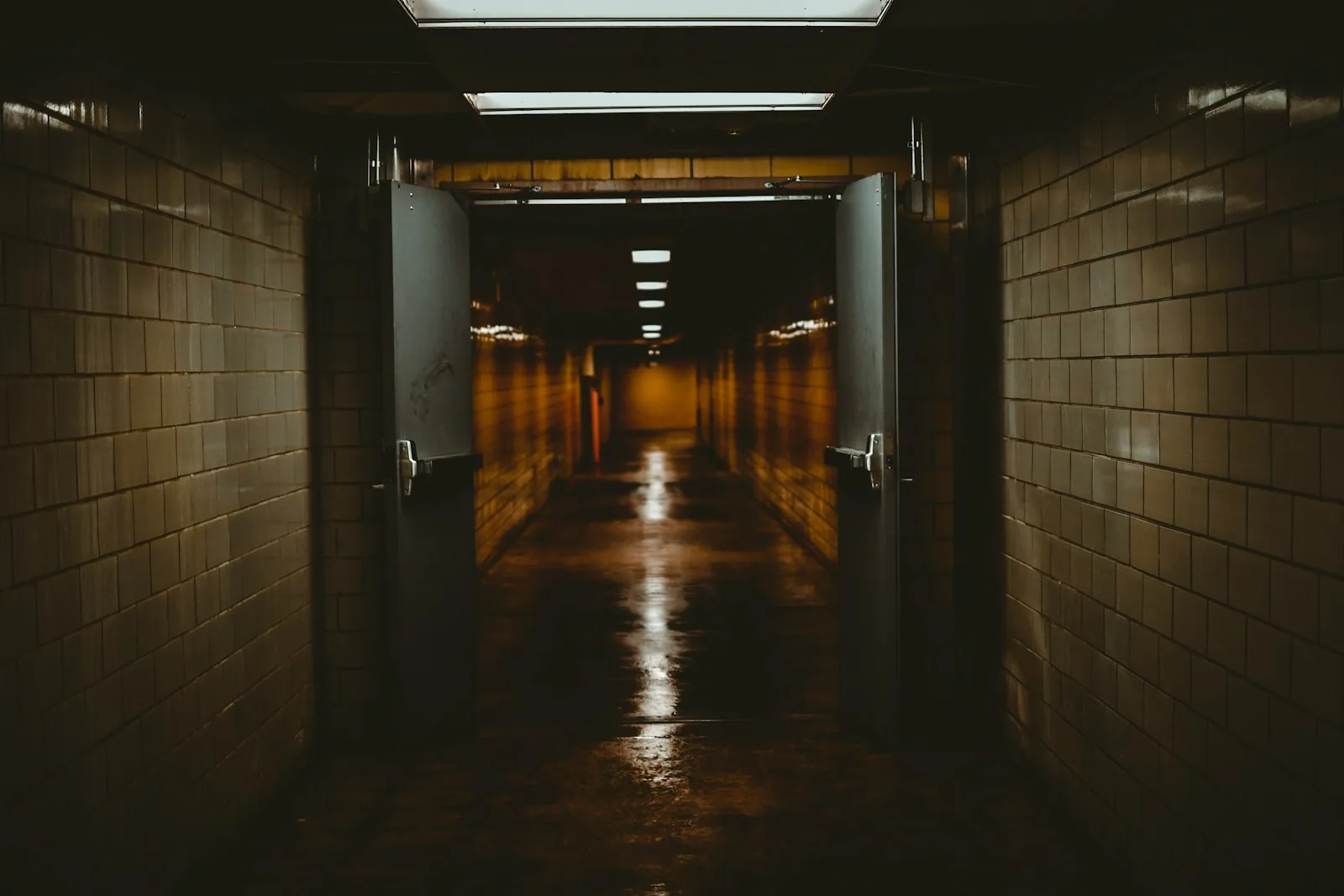 A corridor with its double doors propped open