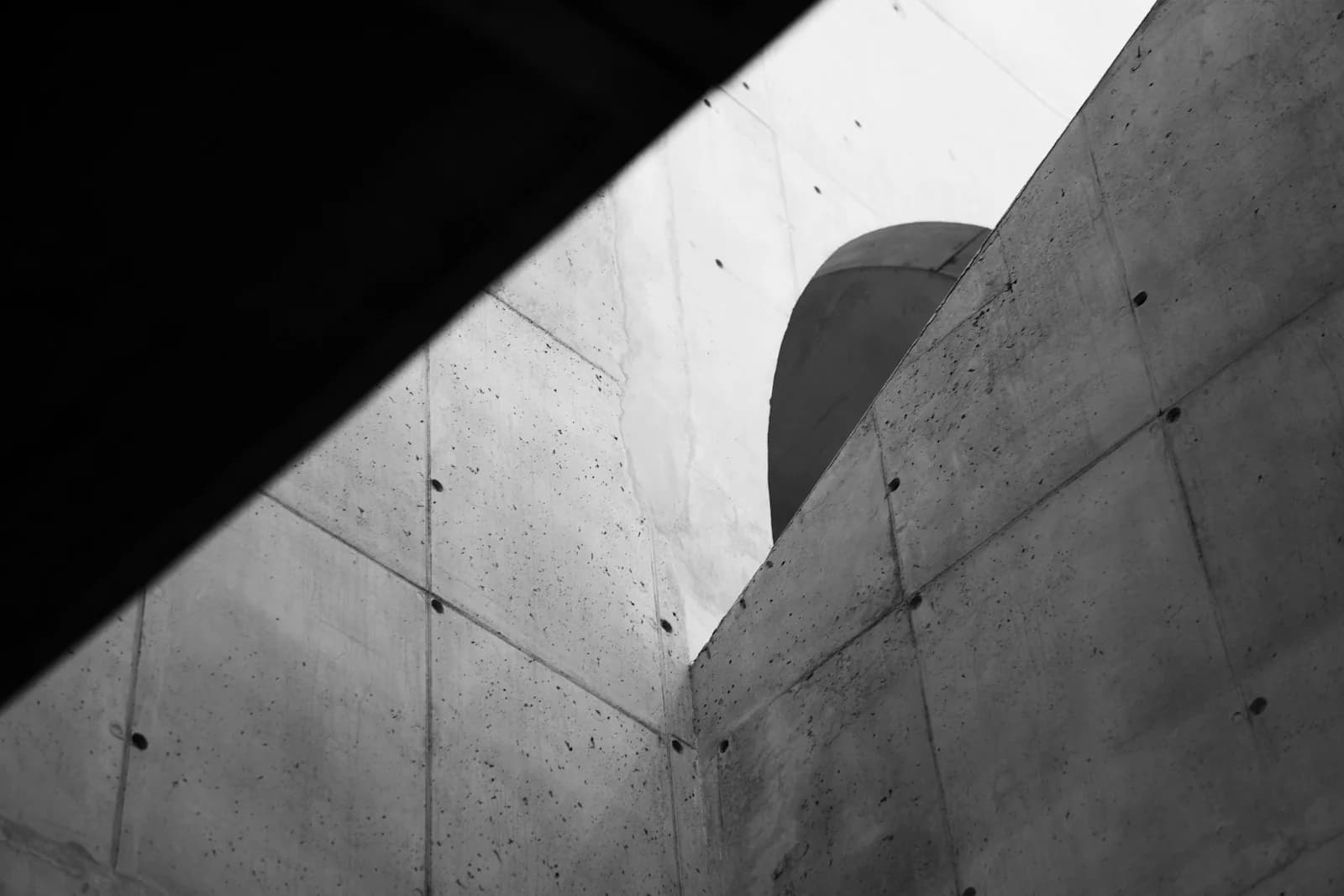 A concrete corner in high-contrast black and white