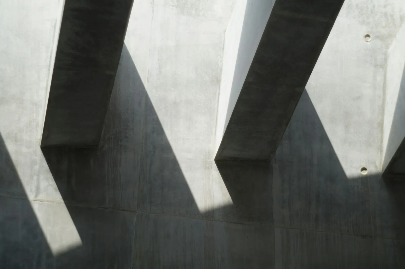 Concrete fins casting hard-edged shadows on a wall