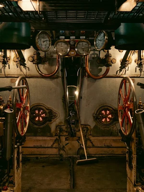 Brass gauges and valve wheels in an engine room